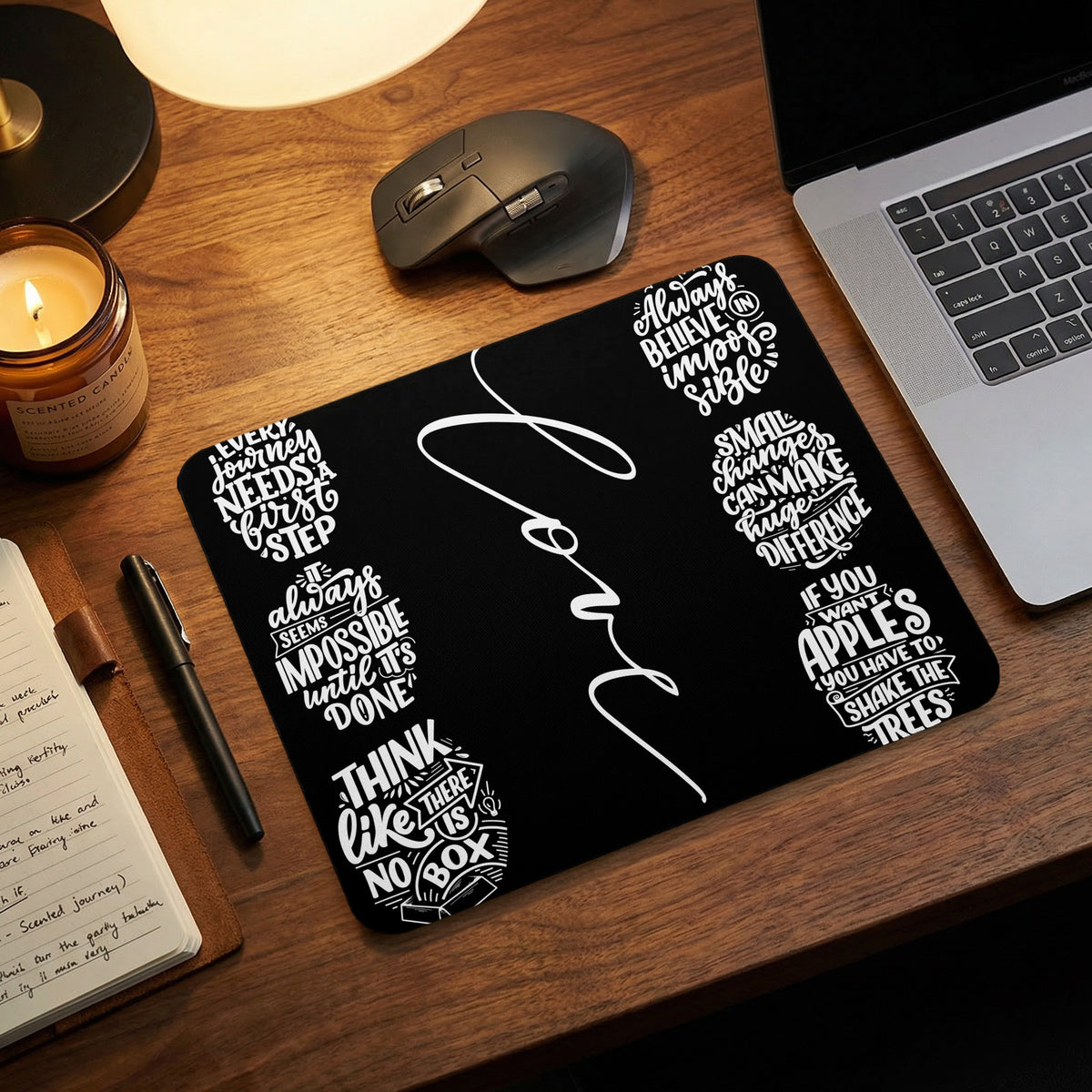 Black mousepad with white typography quotes: "Love", "Every journey needs a first step", and more.