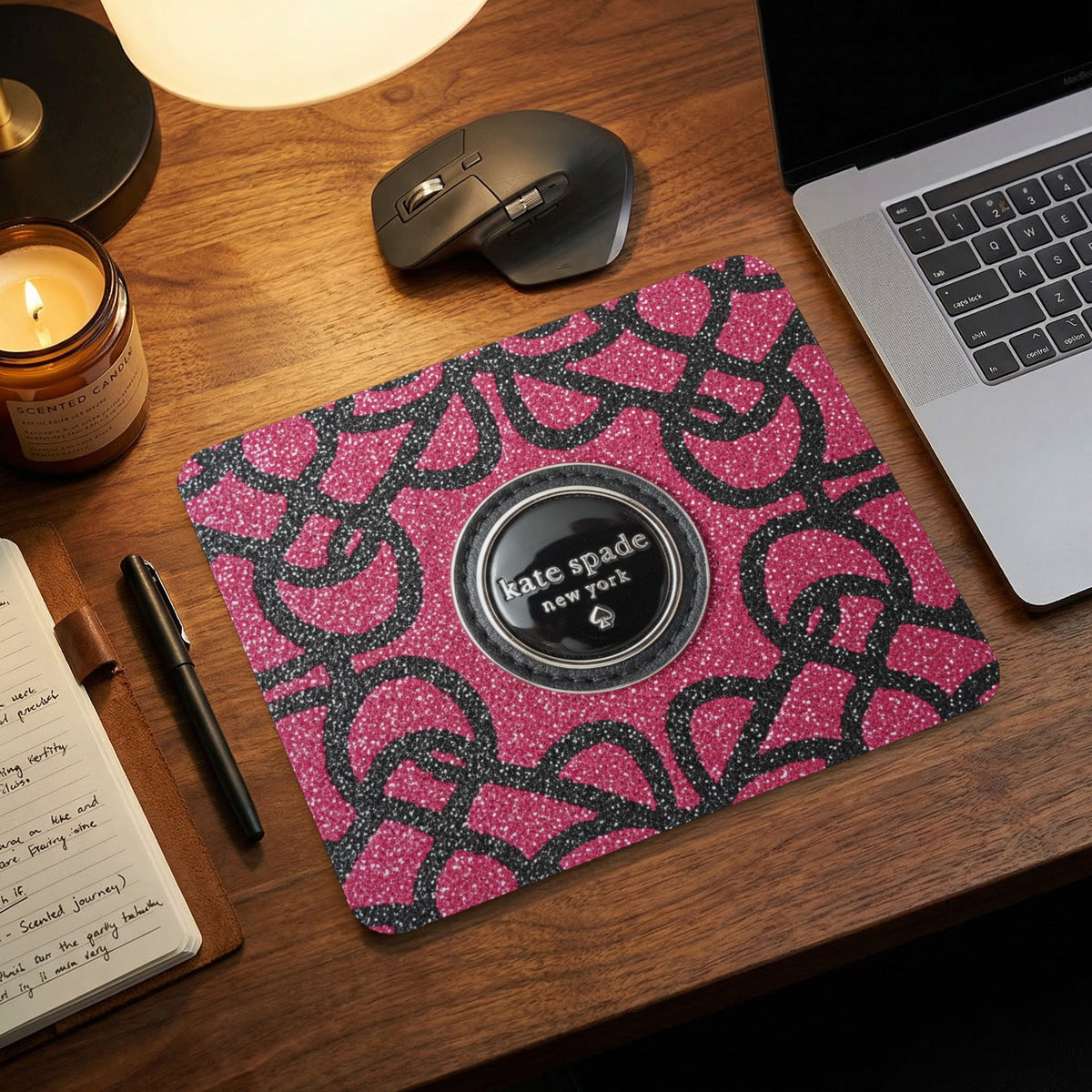 Kate Spade New York mousepad with pink glitter and black abstract pattern.