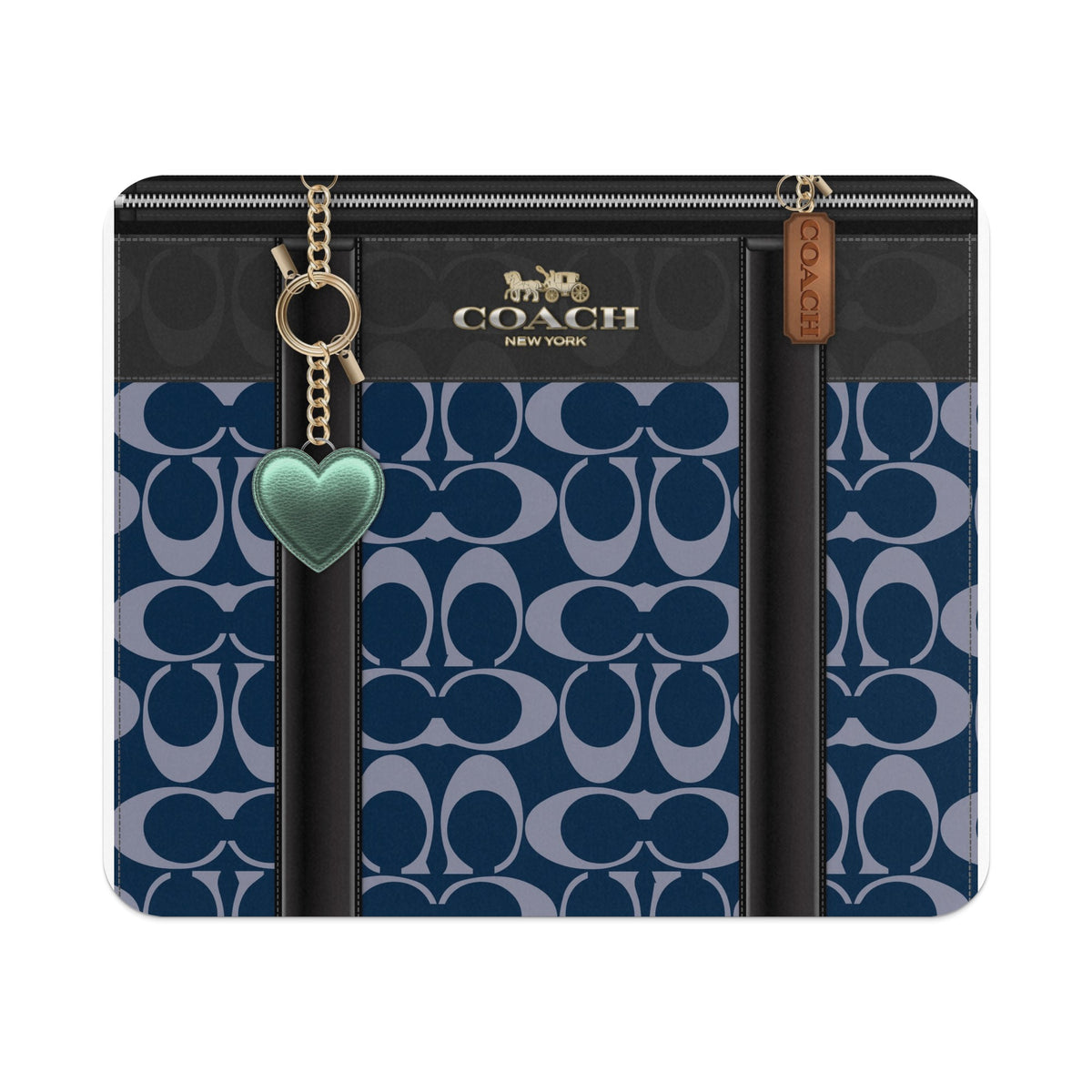 Coach bag with navy signature C pattern, gold hardware, and green heart charm.