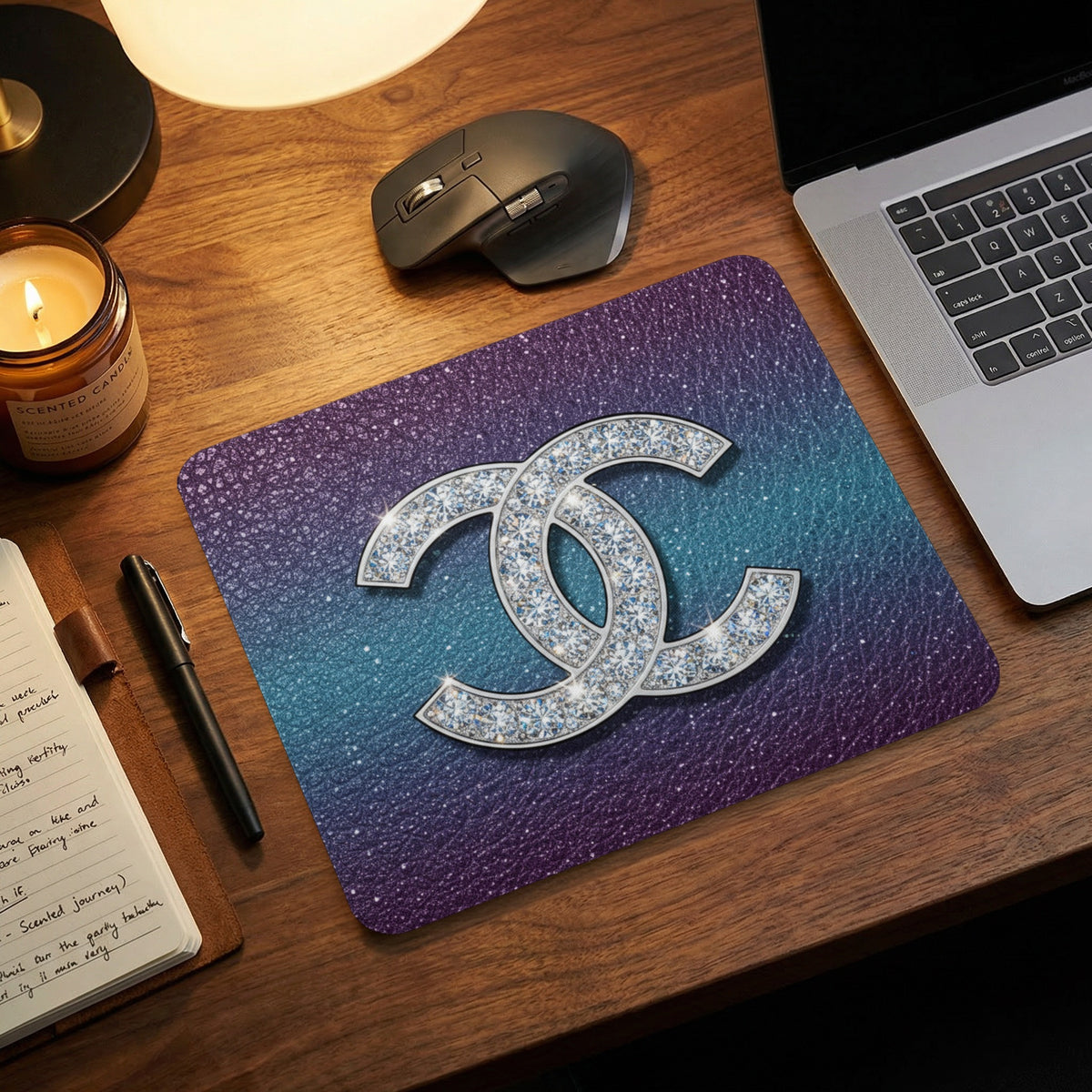 Mousepad with sparkly double C logo on gradient background.