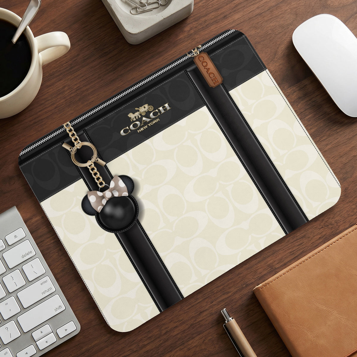 Coach clutch with signature C logo pattern and Minnie Mouse charm.