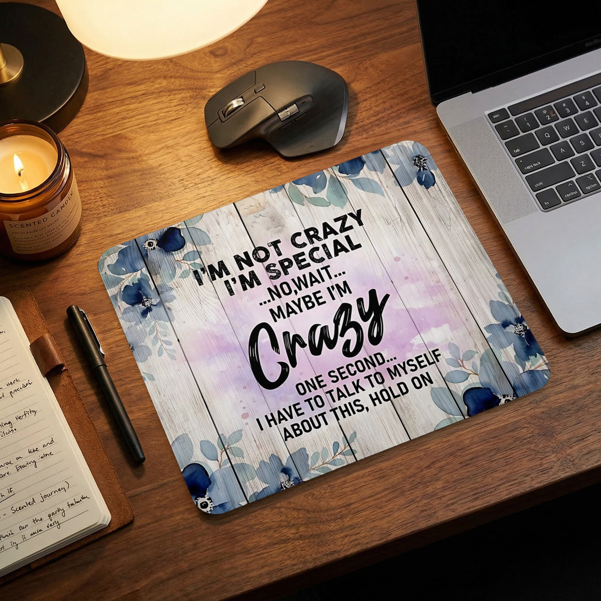 Mousepad with "I'm not crazy, I'm special... maybe I'm crazy" text and floral design.