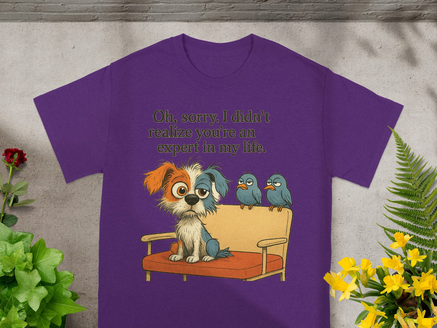 Purple t-shirt featuring a cartoon dog on a couch with three birds and the text "Oh, sorry. I didn't realize you're an expert in my life."