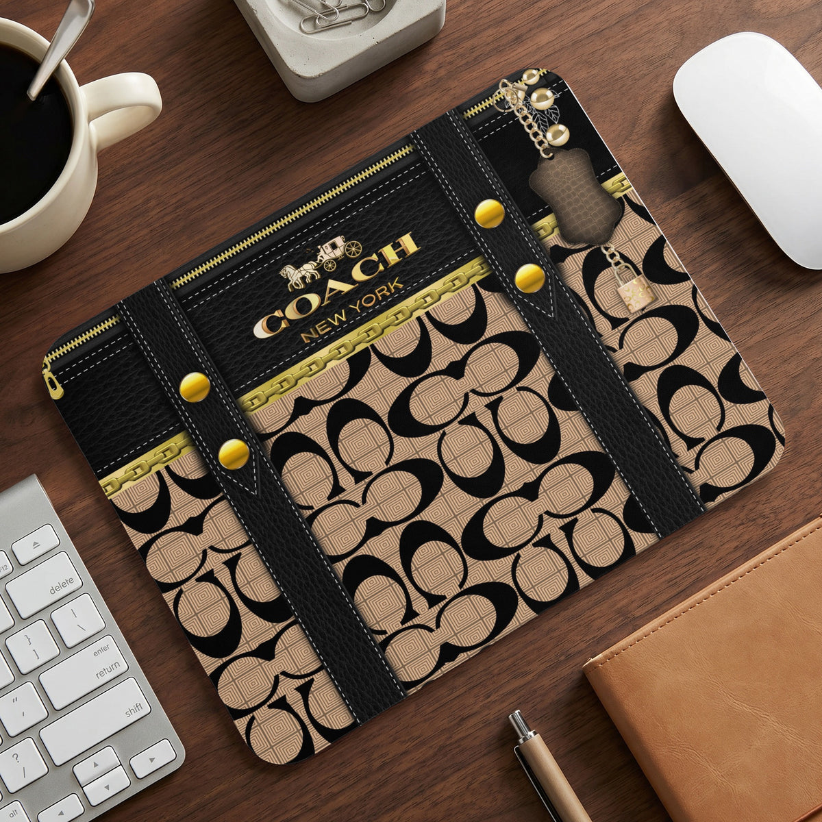 Coach New York pattern mousepad with leather accents and gold hardware.