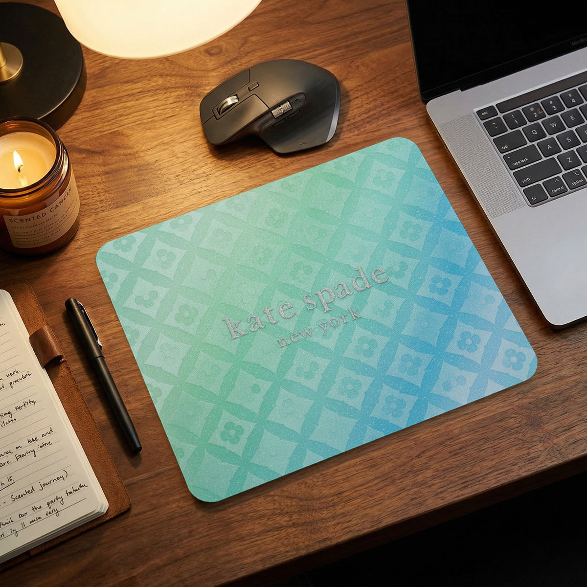 Kate Spade New York mousepad with a green and blue gradient floral pattern.