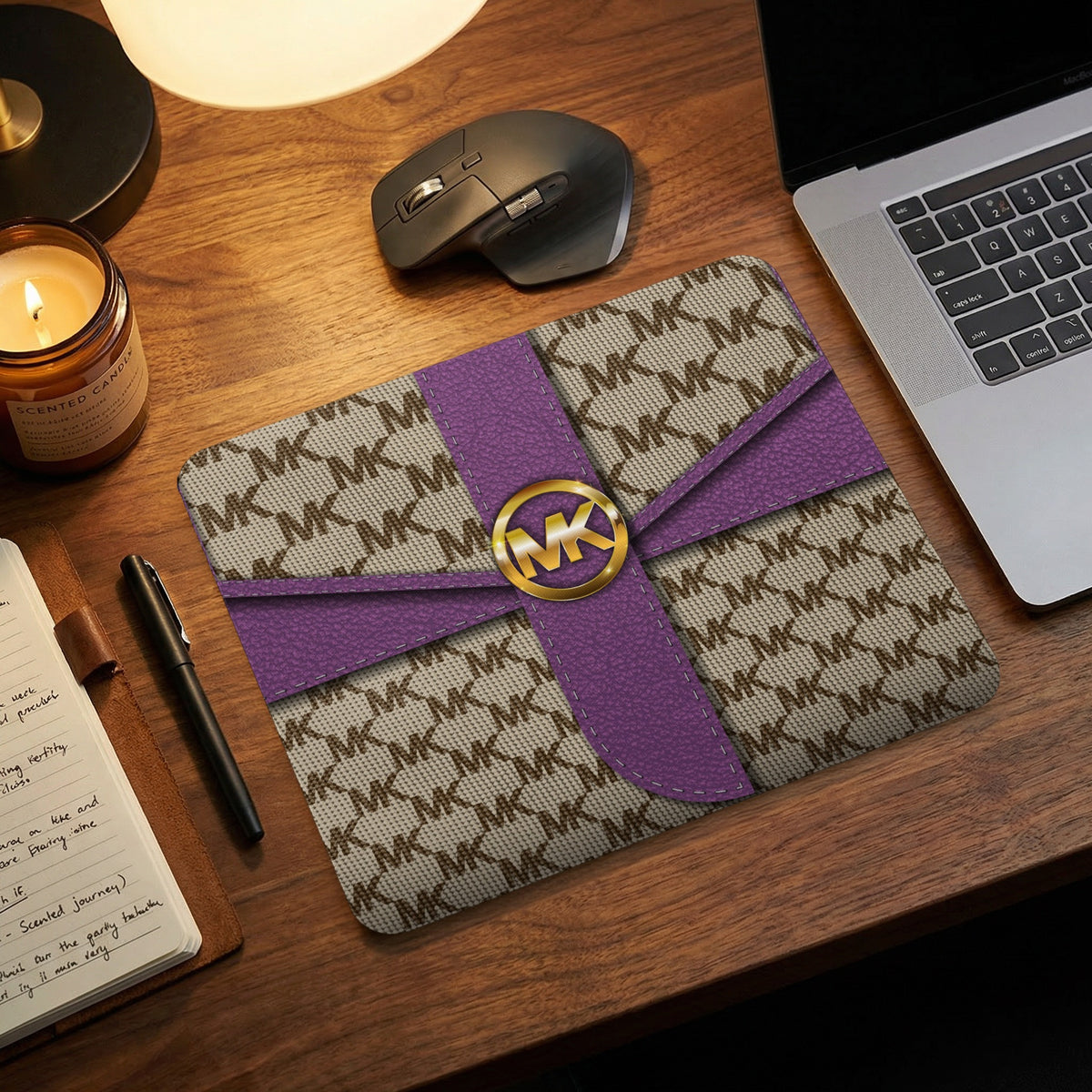 Michael Kors patterned mousepad with purple accent and gold logo.