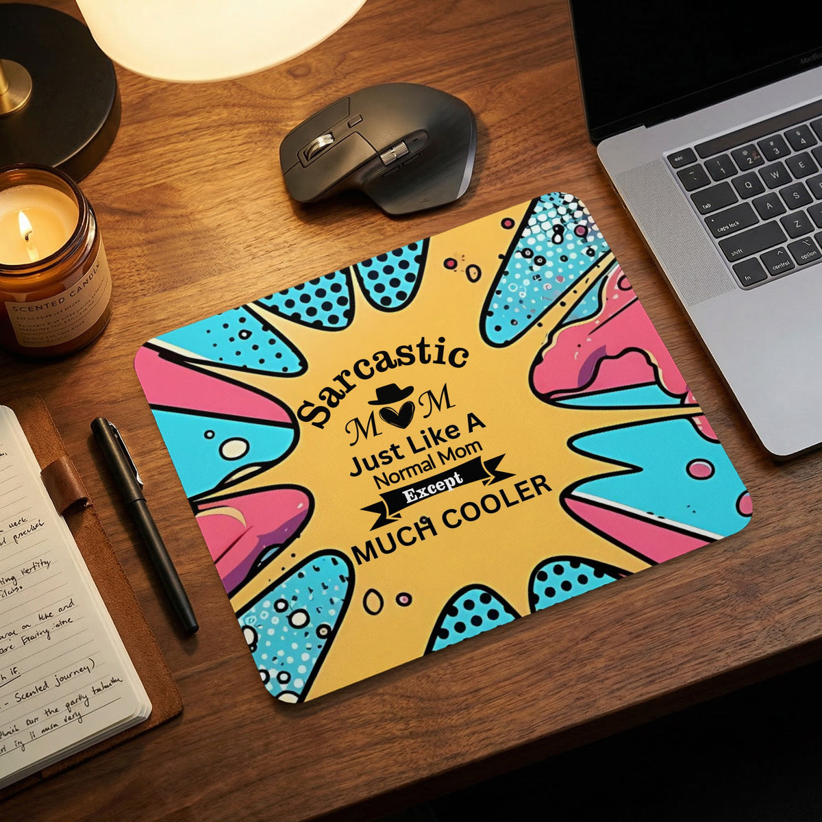 A rectangular mouse pad with pop art design and text reading Sarcastic Mom Just Like A Normal Mom Except Much Cooler rests on a wooden desk.