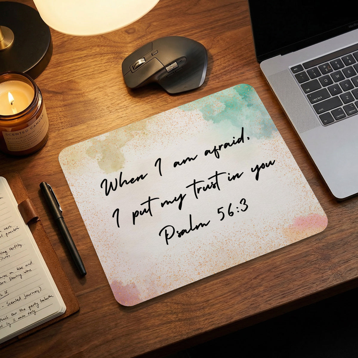 A rectangular mousepad featuring the Bible verse Psalm 56:3 rests on a wooden desk.