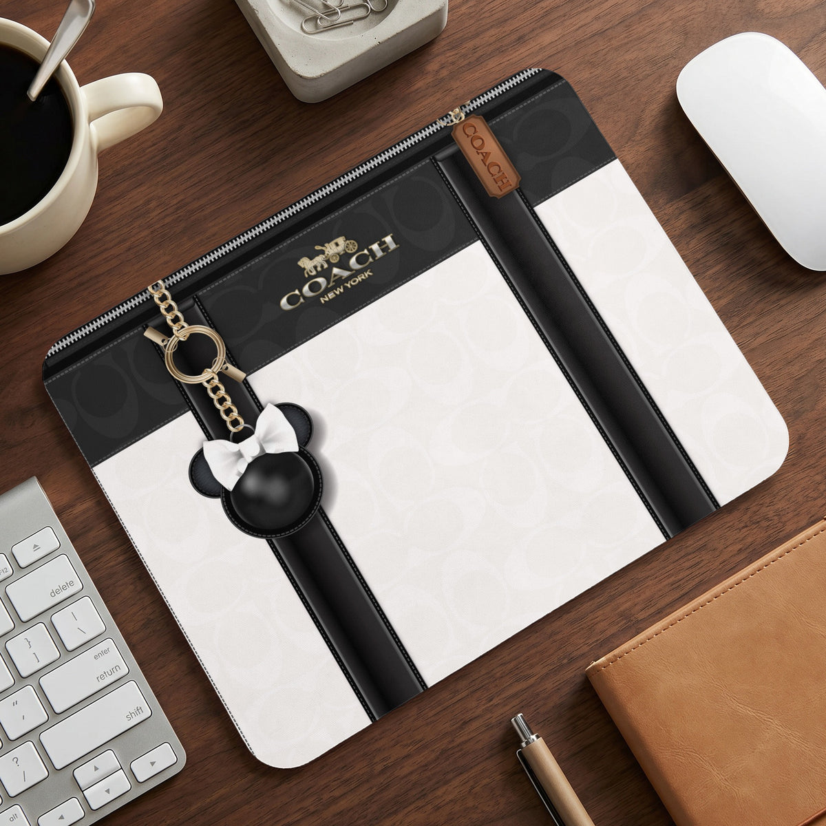 Coach mousepad with black and white pattern and Mickey Mouse charm.