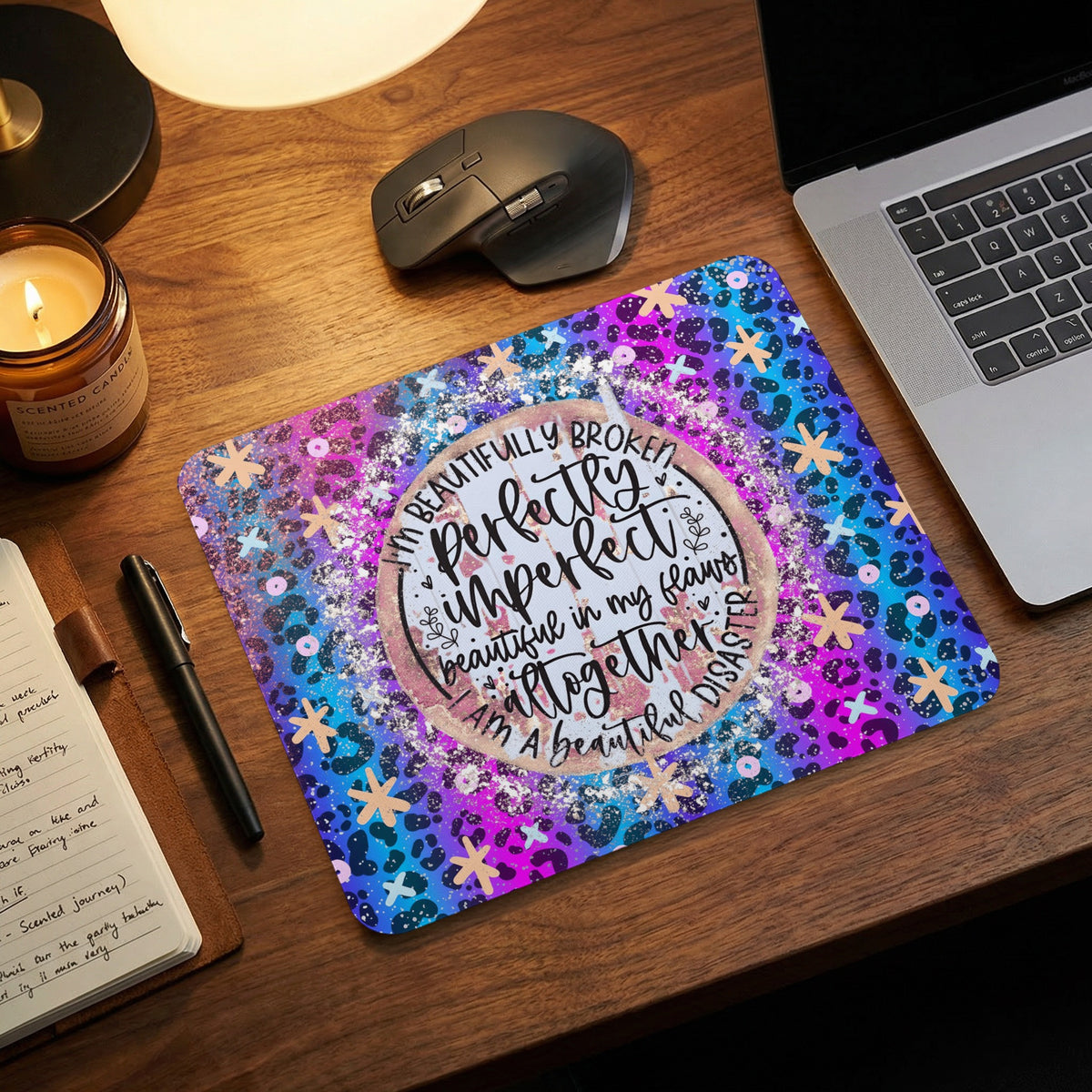 A rectangular mouse pad with a colorful purple, blue, and black animal print background and inspirational text.