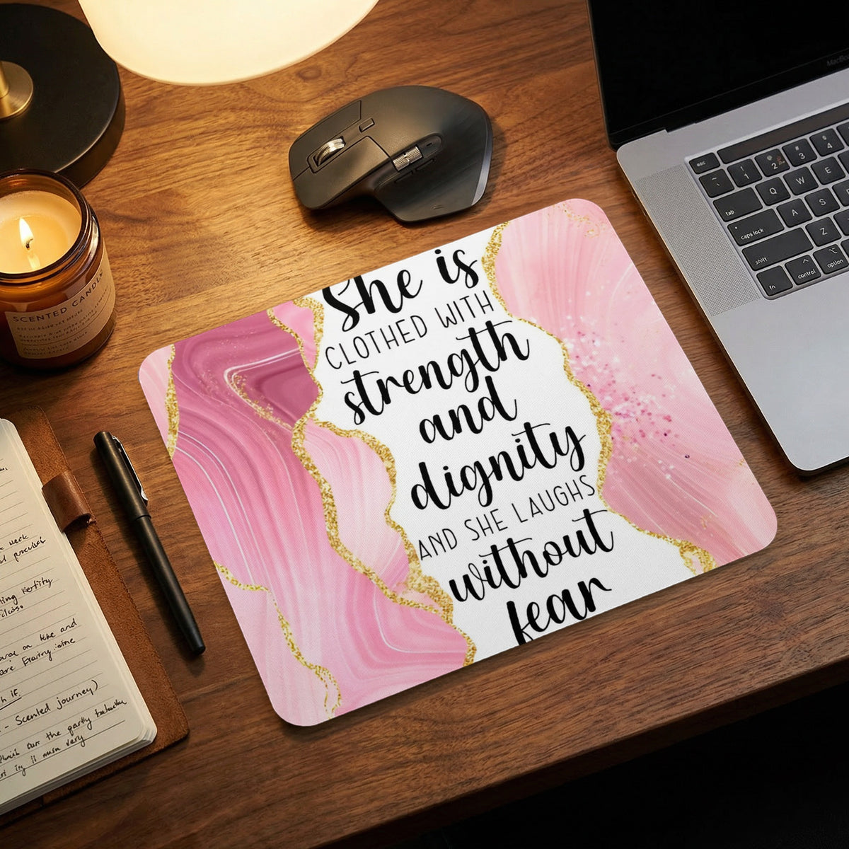 Mousepad with pink marble pattern and quote: "She is clothed with strength and dignity and she laughs without fear."