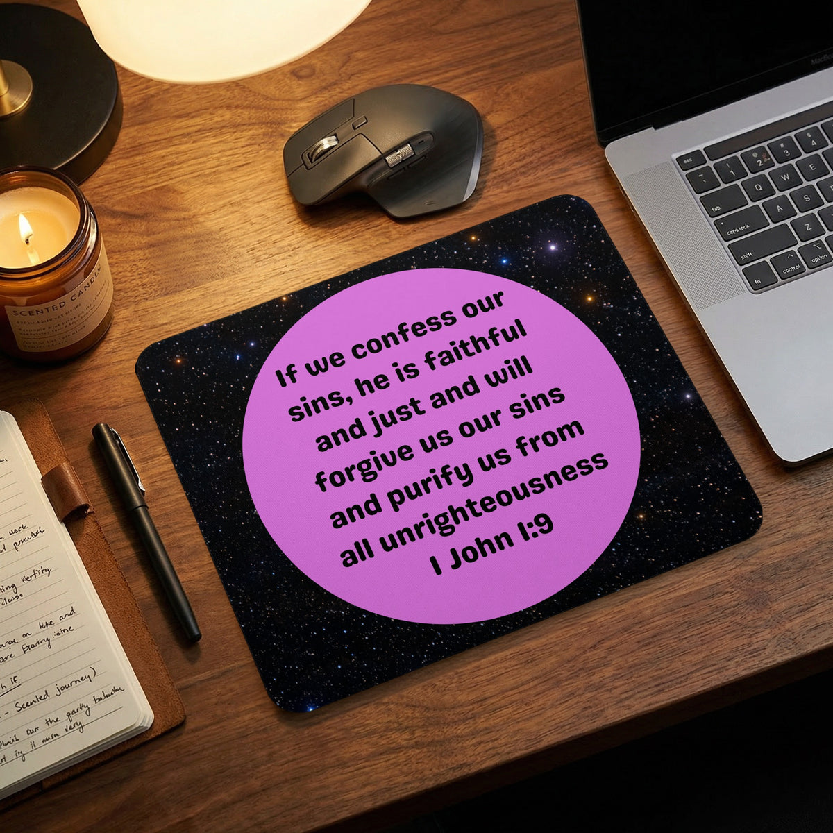 A rectangular mousepad featuring a galaxy background and a pink circle printed with the biblical text 1 John 1:9.