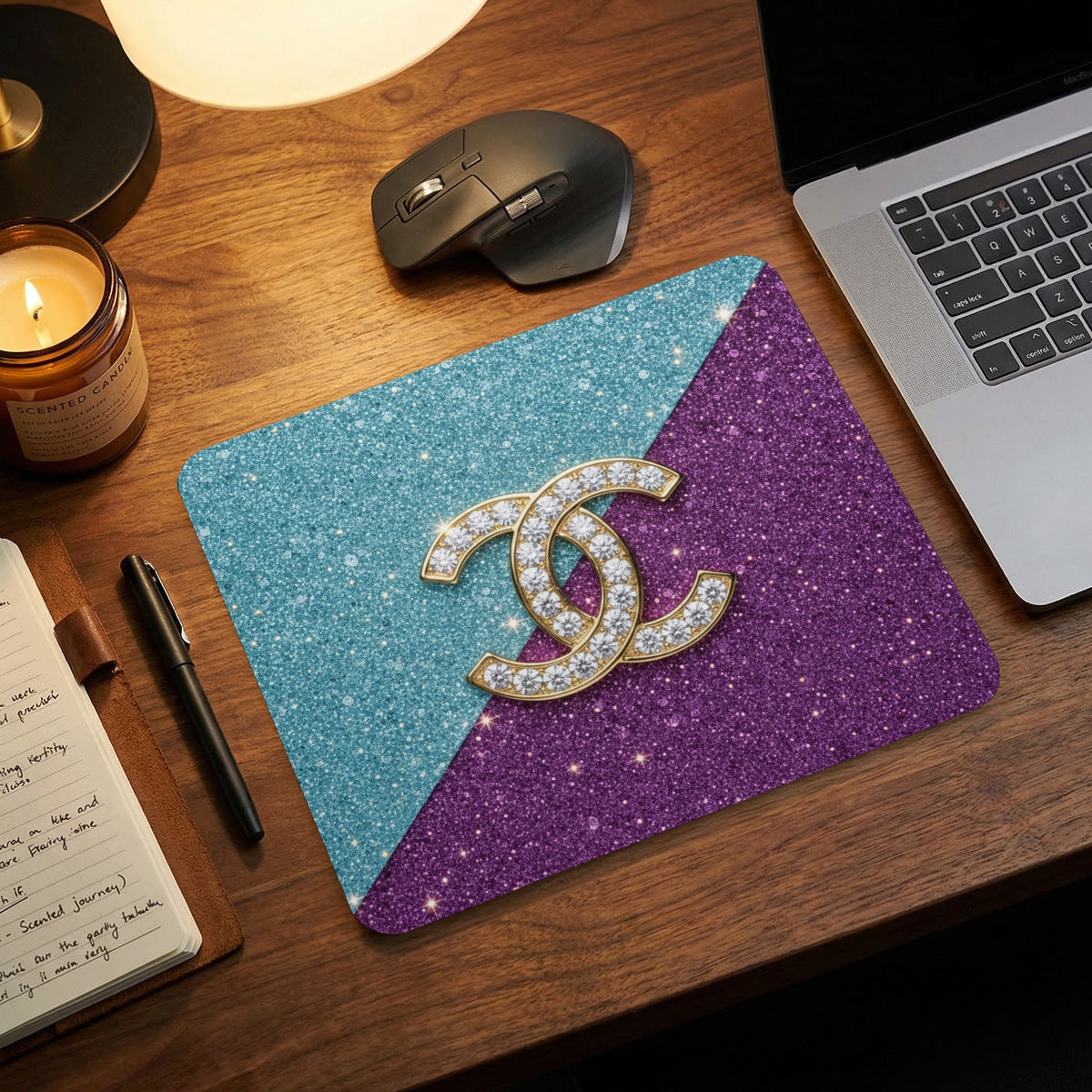 Mousepad with glittery purple and teal halves featuring a gold and rhinestone double C logo.