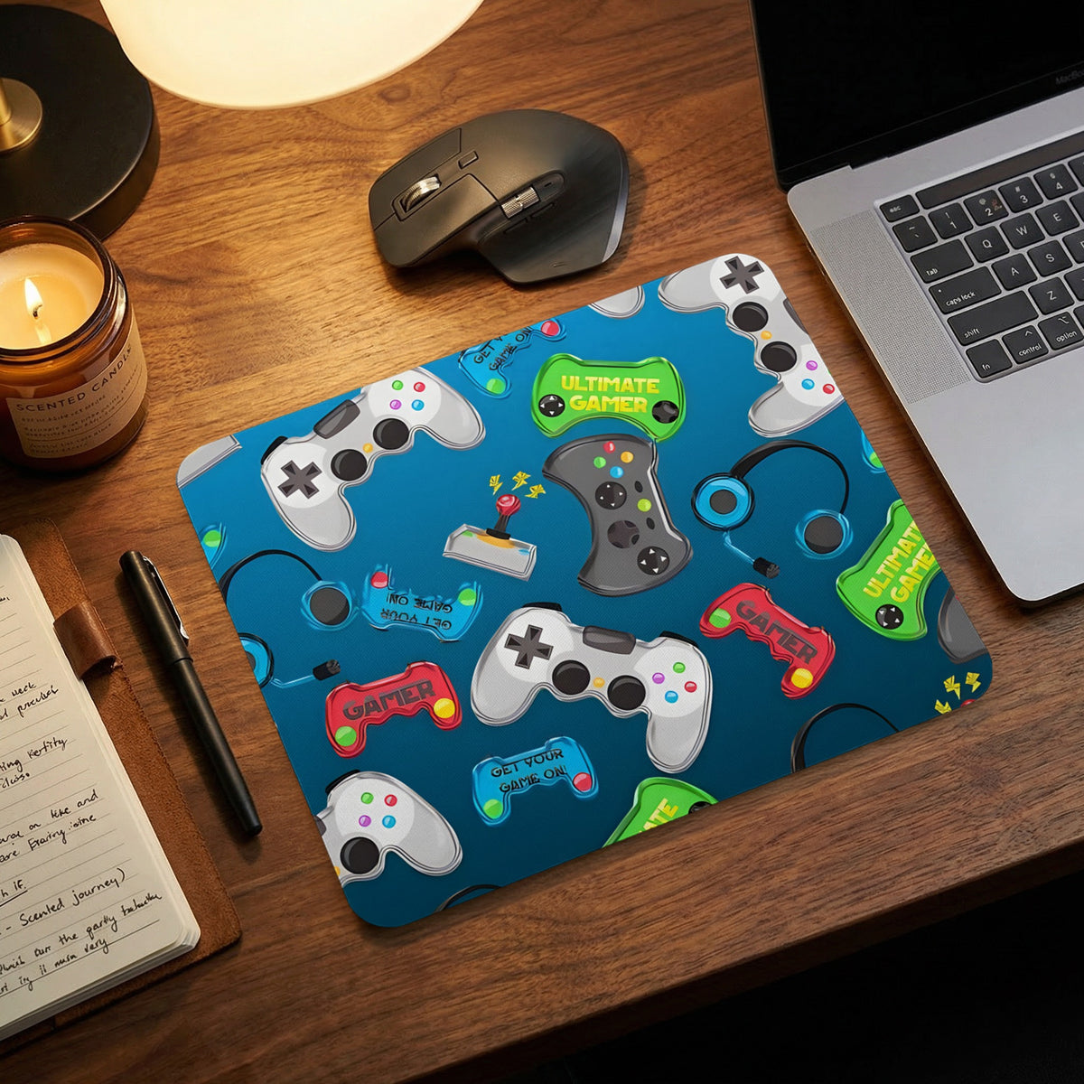 Blue mouse pad with a repeating pattern of gaming controllers, headphones, and text on a wooden desk.