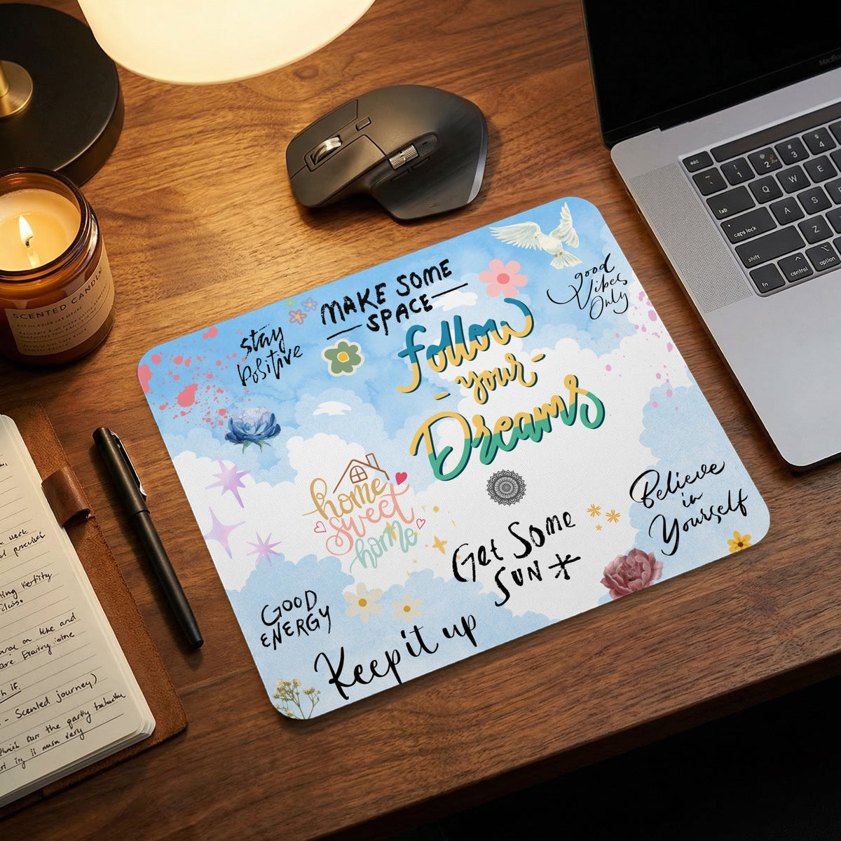 Mousepad with motivational text and floral designs on a sky background.
