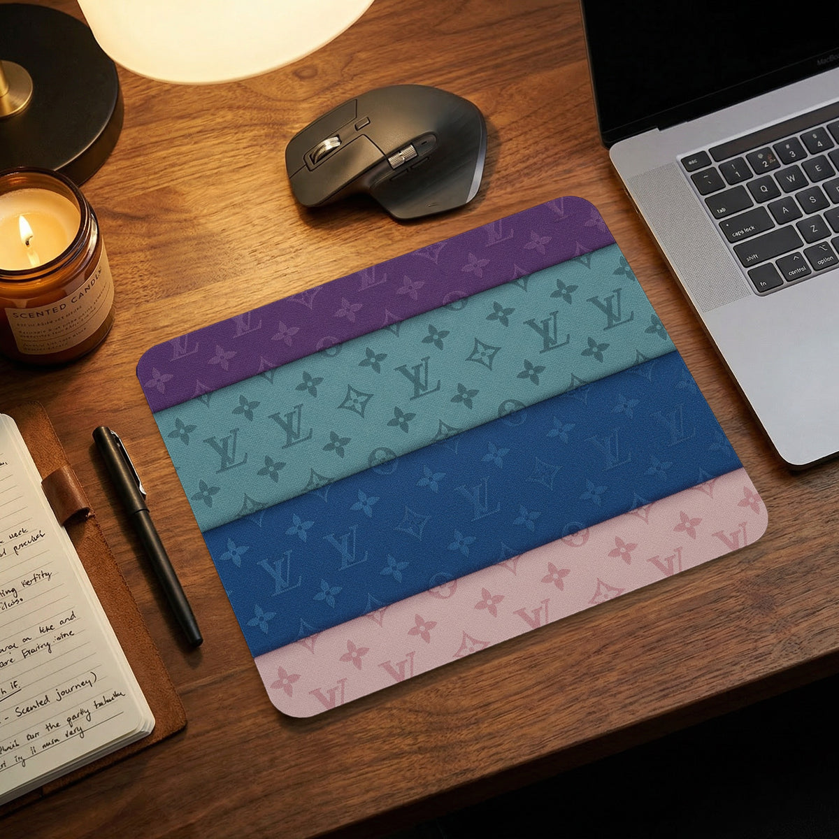 Mousepad with horizontal stripes in purple, teal, blue, and pink with monogram pattern.