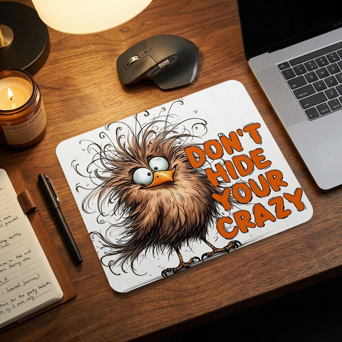 A white rectangular mousepad features a disheveled cartoon bird and the text Don't Hide Your Crazy.