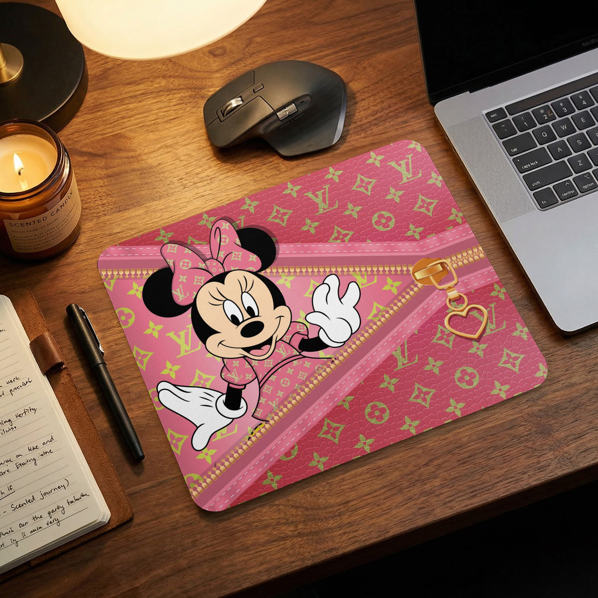 Minnie Mouse on a pink mousepad with a gold zipper and heart charm.