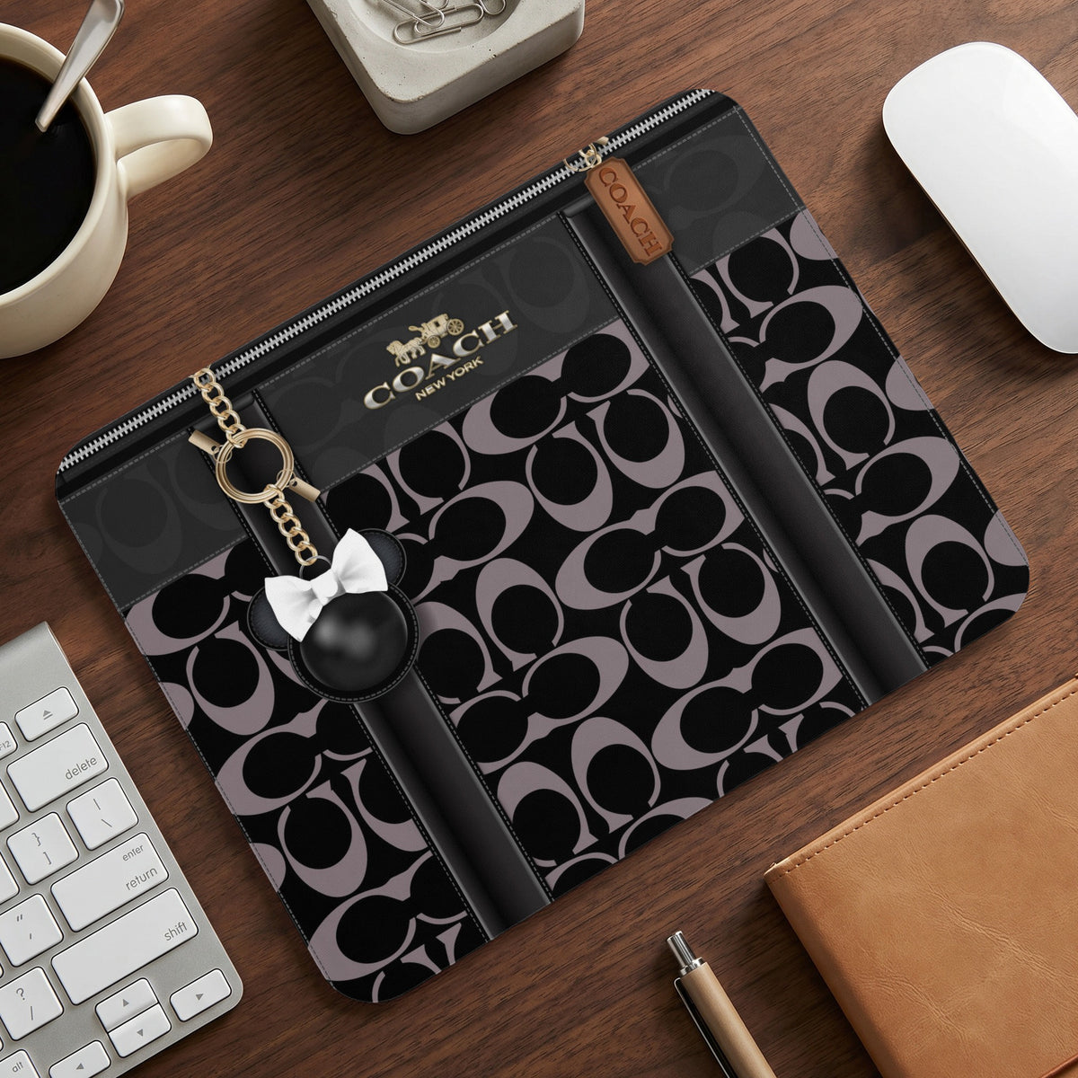 Coach black and grey monogram laptop sleeve with Minnie Mouse charm.