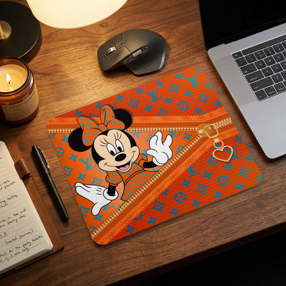 Minnie Mouse on orange mousepad with blue logo pattern and gold zipper detail.