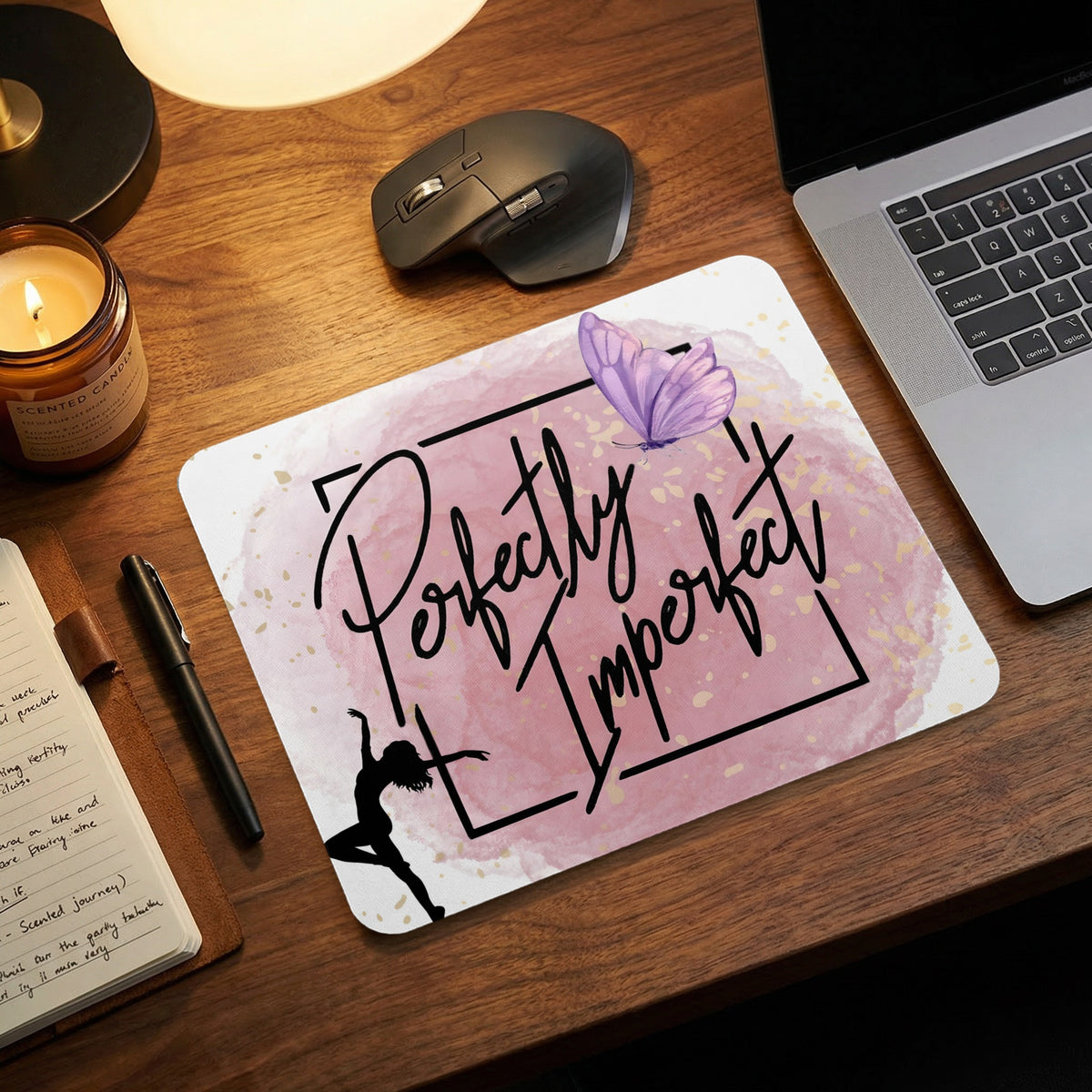 A rectangular mouse pad with a pink watercolor background, featuring the phrase Perfectly Imperfect, a dancing silhouette, and a purple butterfly.