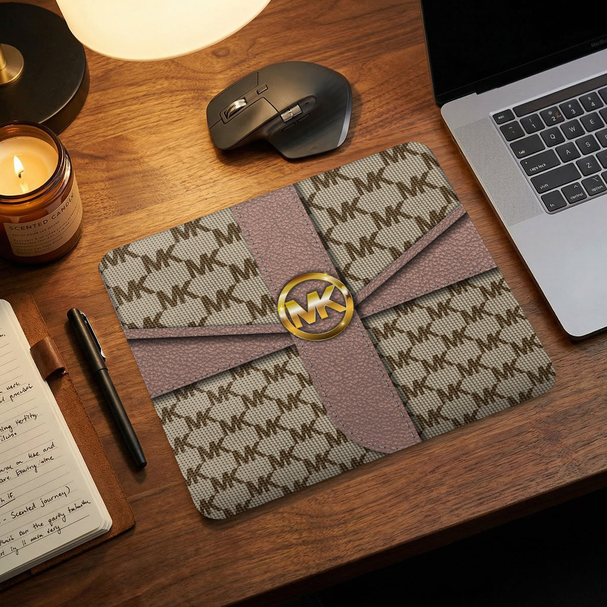 Michael Kors MK logo patterned mousepad with pink ribbon and gold emblem.