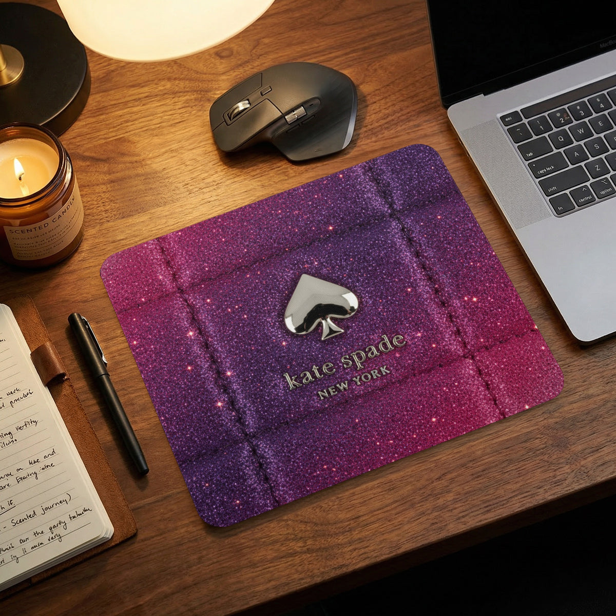 Kate Spade New York mousepad with purple glitter gradient and spade logo.