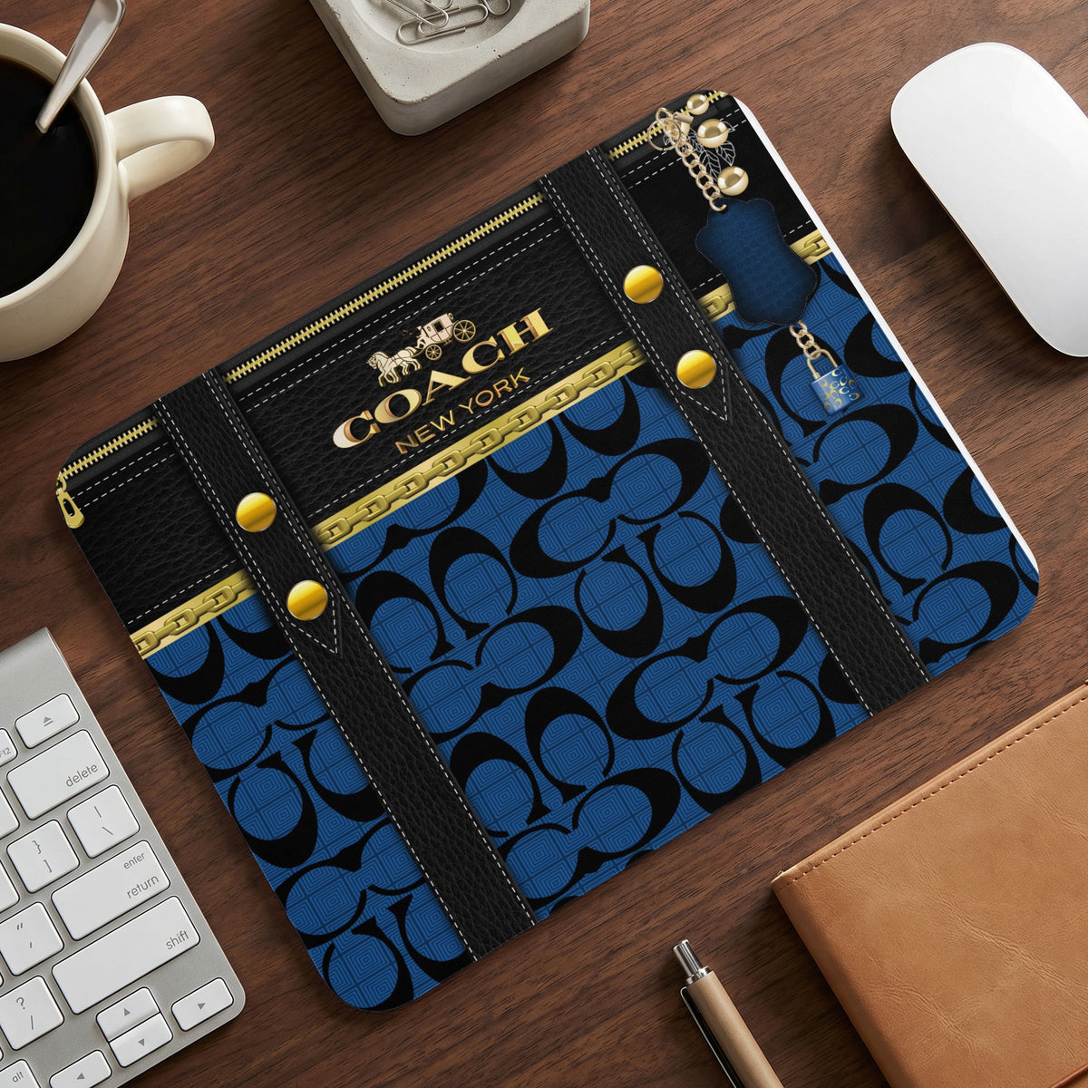 Coach New York mousepad with blue pattern and gold hardware.