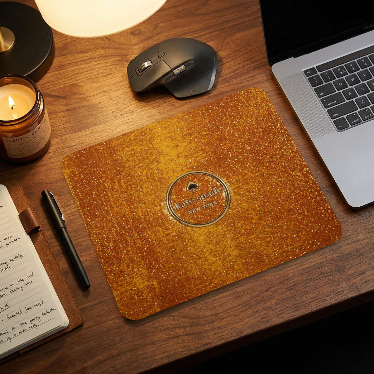 Kate Spade New York glitter mousepad on a wooden desk with laptop.