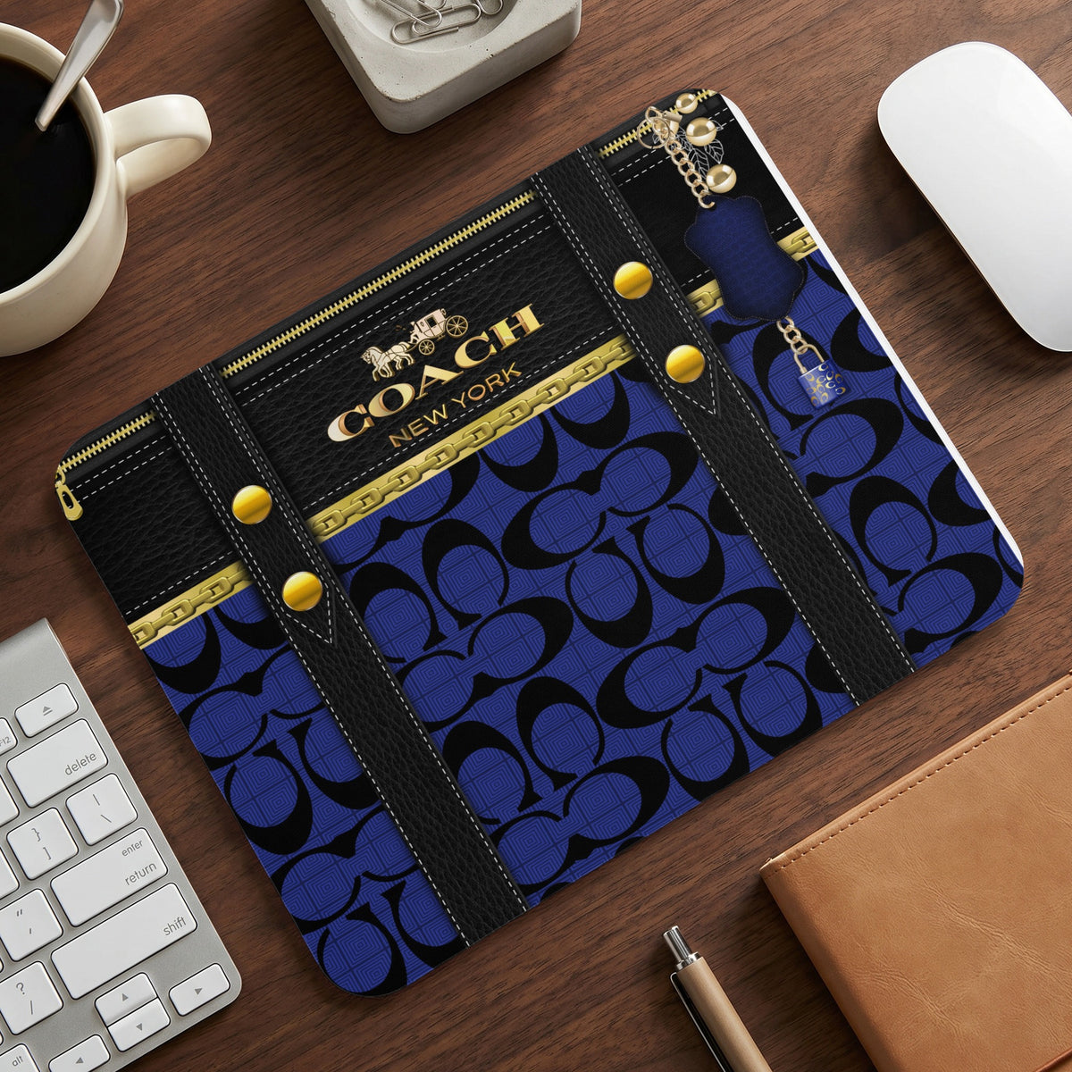 Coach New York mousepad with black and blue monogram pattern and gold hardware.
