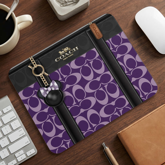 Coach C monogram mousepad with a Minnie Mouse charm and keychain.