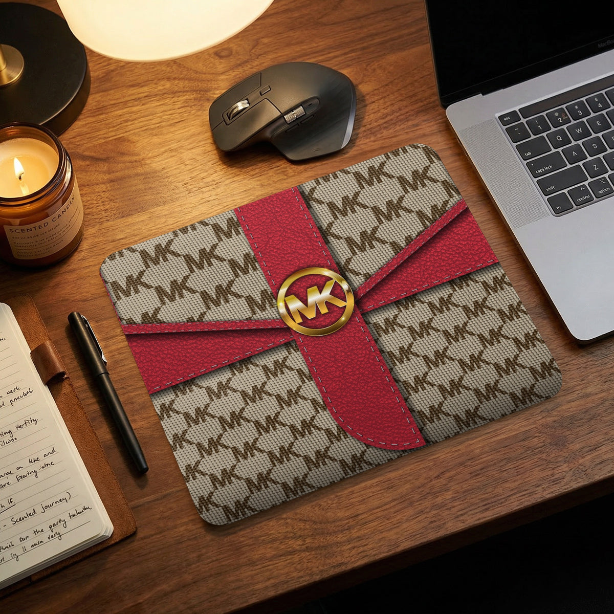 Michael Kors logo mousepad with MK monogram and red ribbon detail.