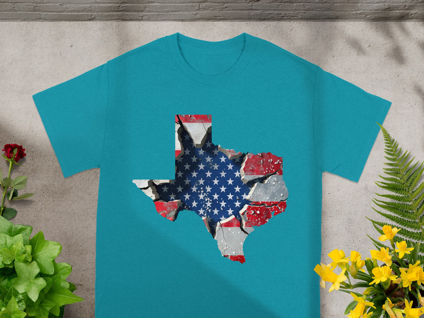 Teal t-shirt with a Texas map outline filled with a cracked American flag design.