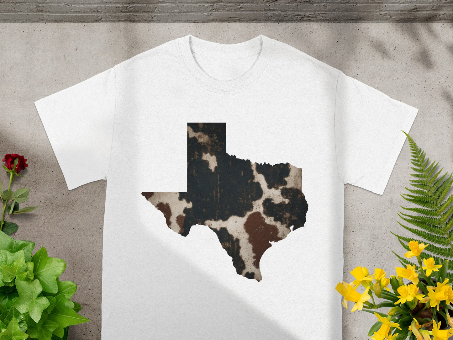 White t-shirt with Texas shape featuring cowhide print design.