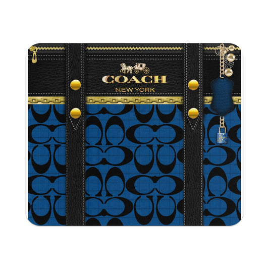 Coach pattern on blue with black leather trim, gold zipper, and keychain lock.