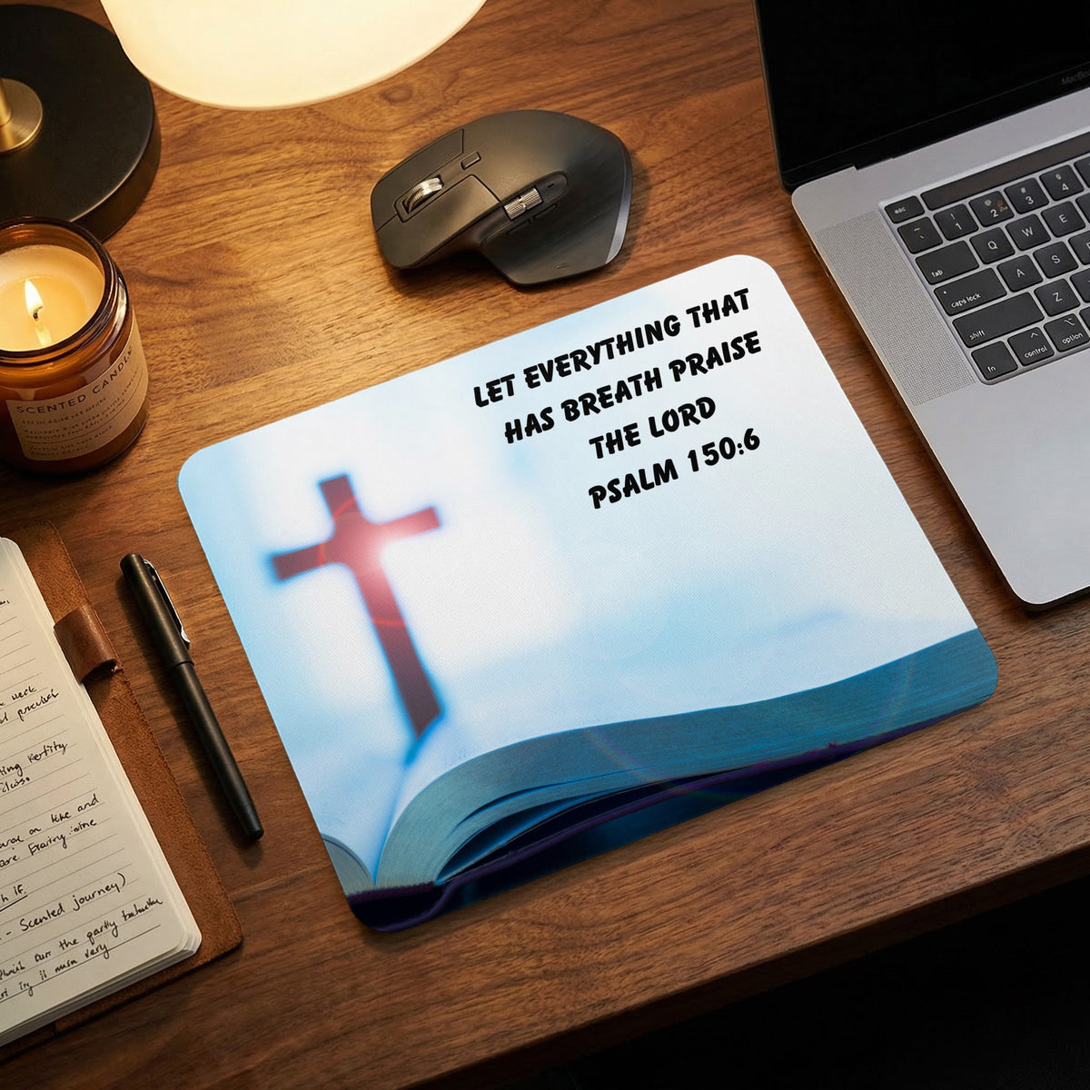Mousepad featuring an open Bible and cross, with Psalm 150:6 text, on a wooden desk.