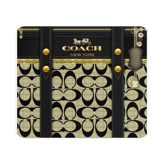 Coach New York black leather bag with gold hardware and monogram pattern.