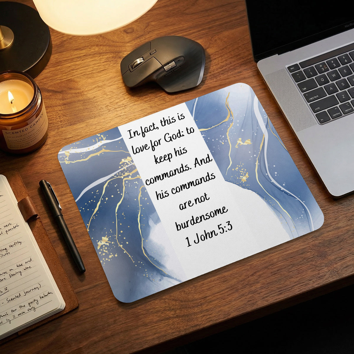 Blue and white marble mouse pad featuring the Bible verse 1 John 5:3 on a wooden desk.