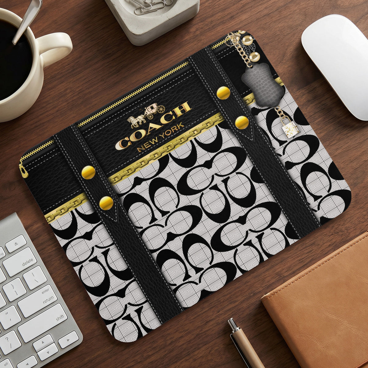 Coach New York mousepad with black and white pattern and gold accents.