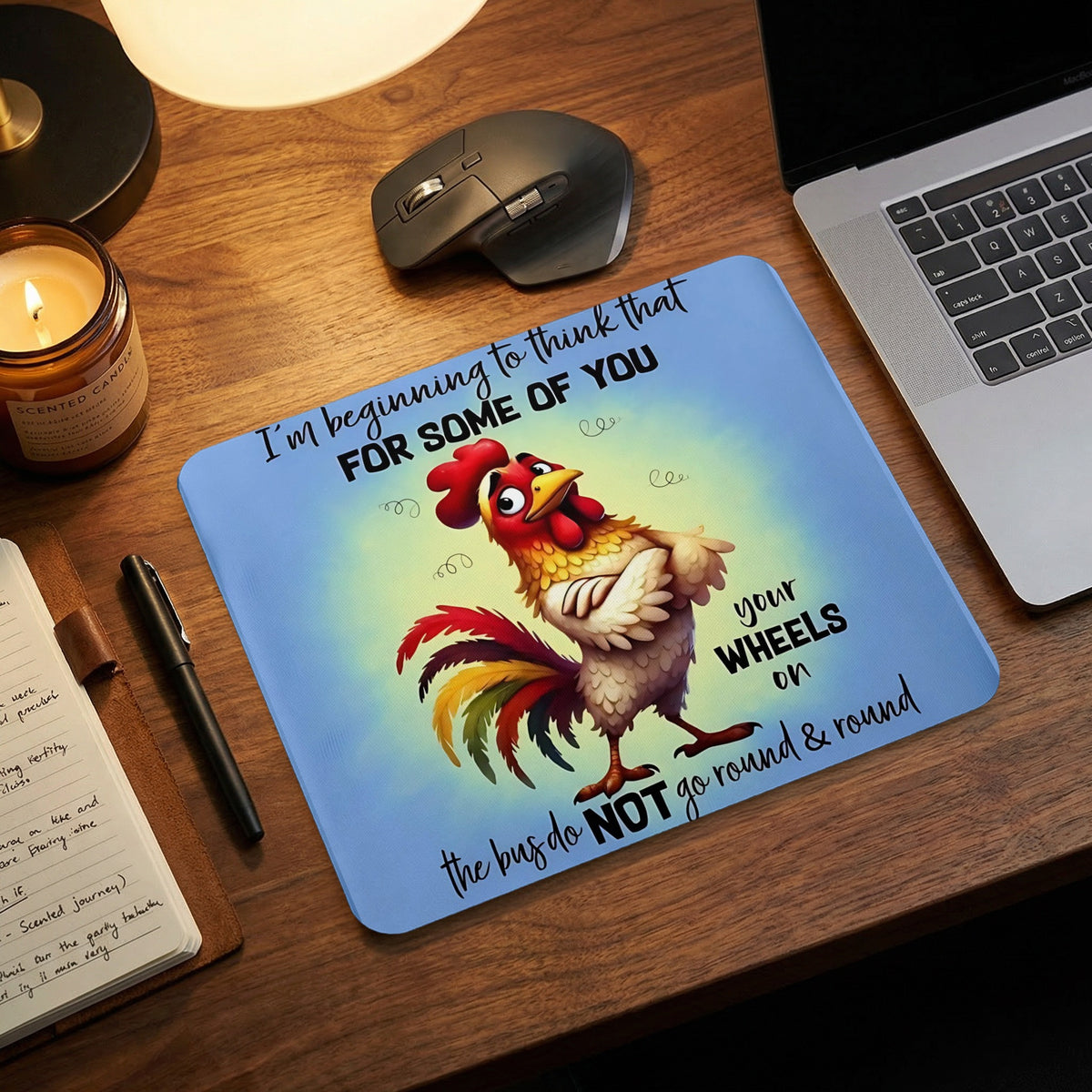 A light blue mousepad featuring a cartoon rooster and the text, I am beginning to think that for some of you your wheels on the bus do NOT go round and round.