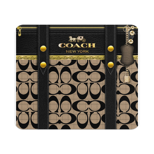 Coach New York logo with signature "C" pattern, gold chain, and padlock charm.