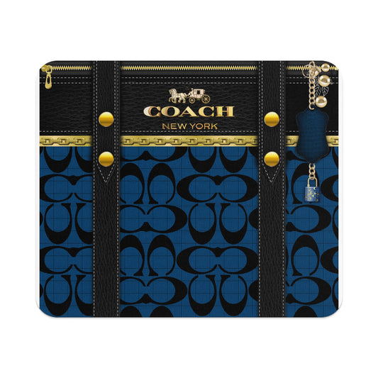 Coach New York monogram pattern mousepad with black leather straps and gold hardware.