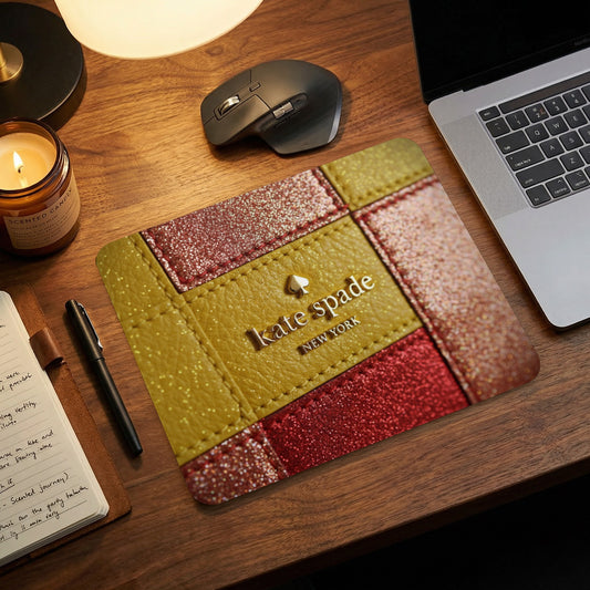 Kate Spade New York logo on a gold and red glitter mousepad.