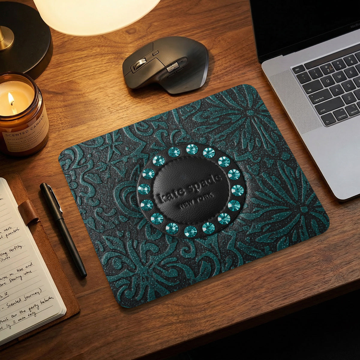 Kate Spade New York mousepad with teal floral pattern and jeweled logo.