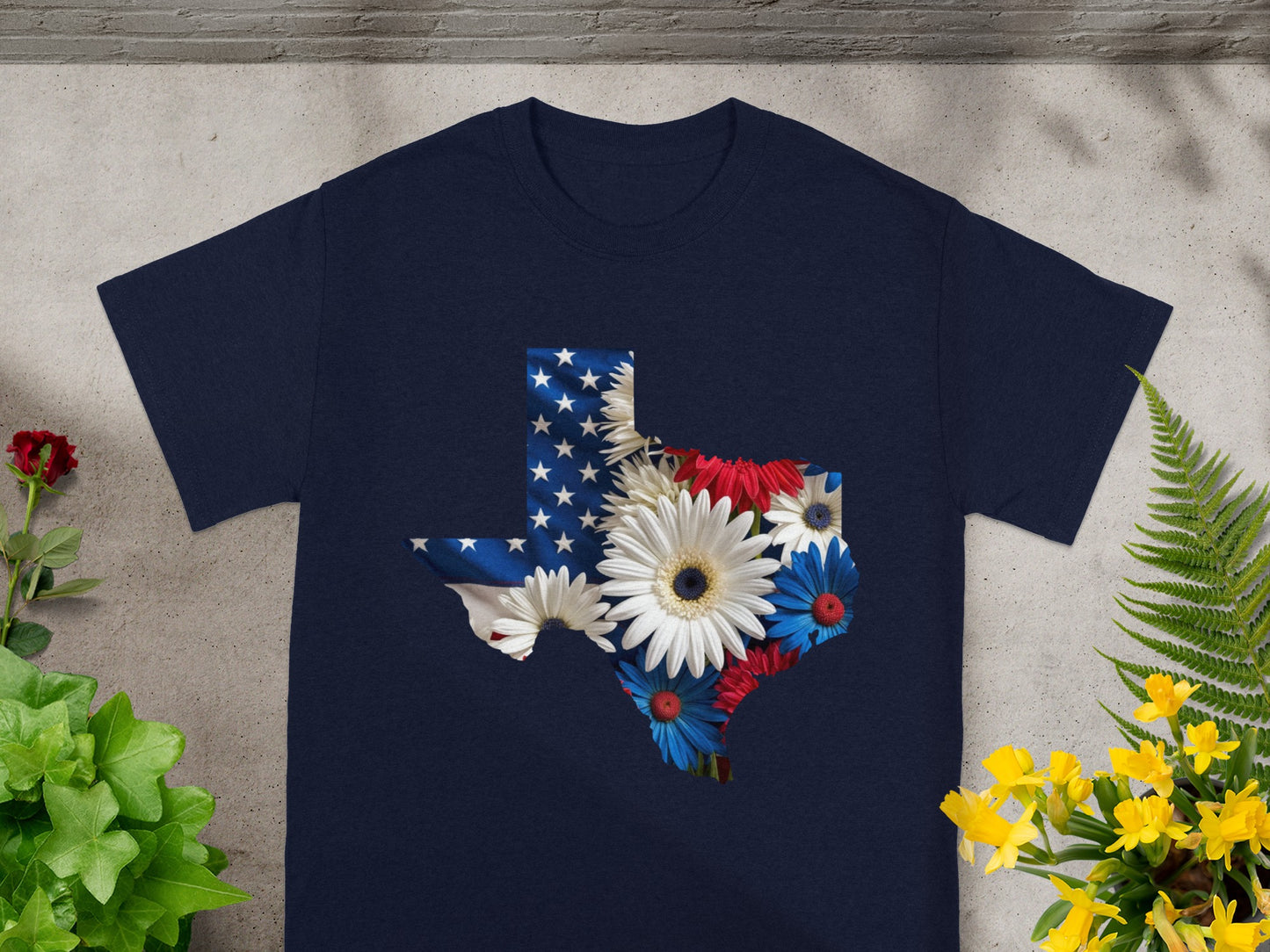 Navy t-shirt with Texas outline filled with US flag and red, white, and blue flowers.