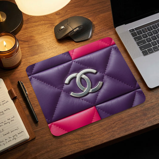 Purple and pink quilted mousepad with silver double C logo.