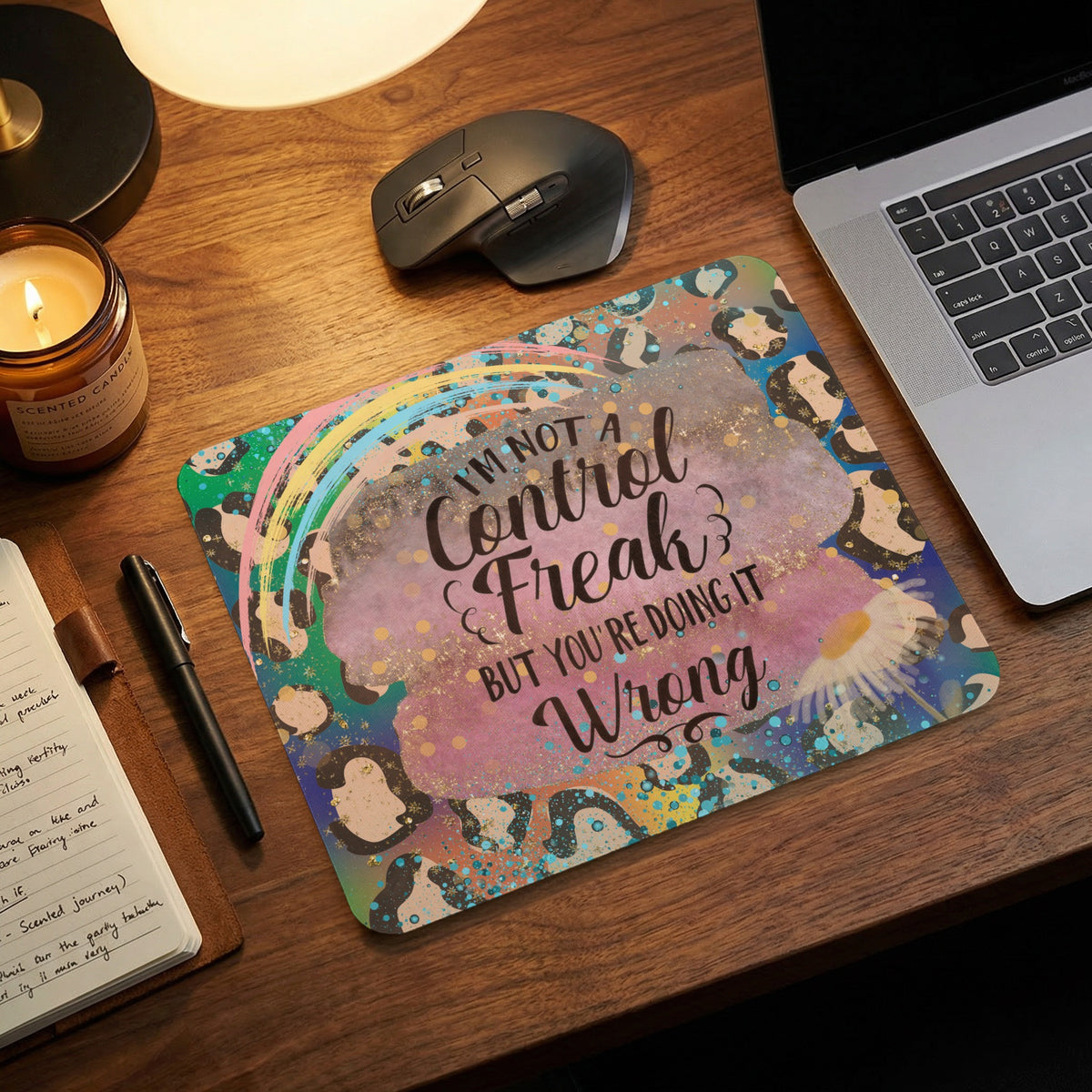 A mouse pad with leopard print, a rainbow, and the text Im not a control freak but youre doing it wrong.