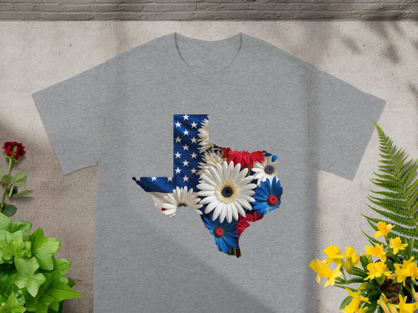 Grey t-shirt with Texas shape filled with American flag and red, white, blue flowers.