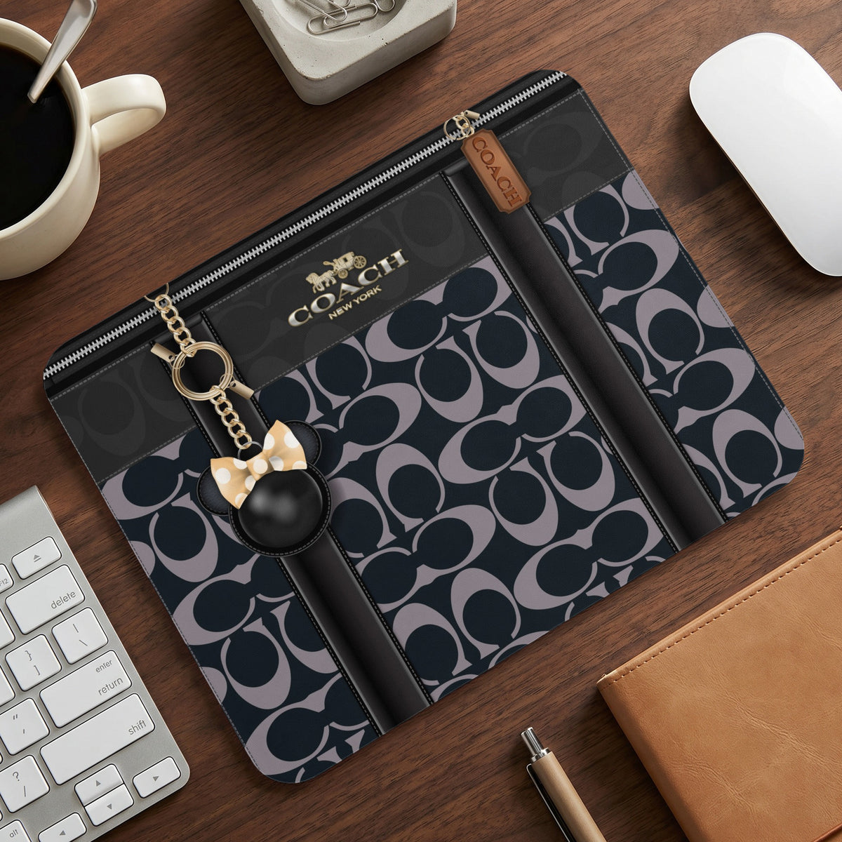 Coach clutch with signature C pattern, Mickey Mouse charm, and "COACH NEW YORK" logo.