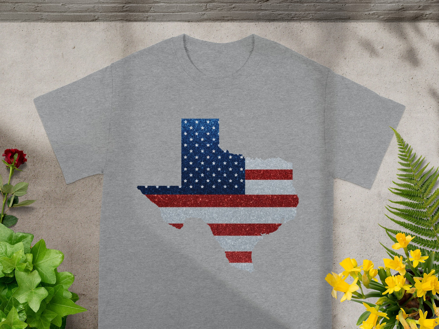 Grey t-shirt with Texas shape filled with American flag pattern.